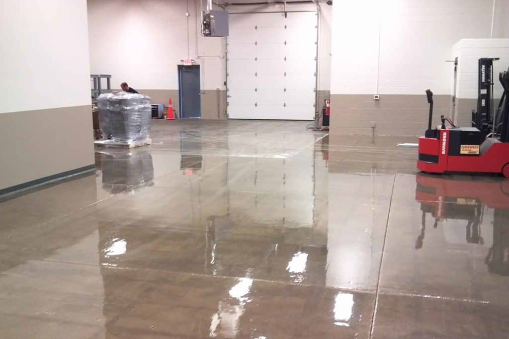 Sealed concrete floor prepared for epoxy coating in industrial setting